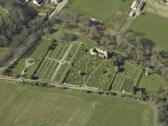Oblique aerial view centred on the chapel, burial-ground and monument, taken from the ESE.