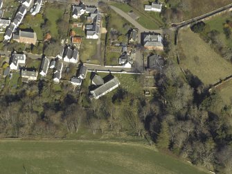 Oblique aerial view centred on the church and the burial-ground, taken from the SW.