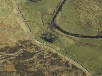 Oblique aerial view centred on the church and the remains of the broch, taken from the WNW.