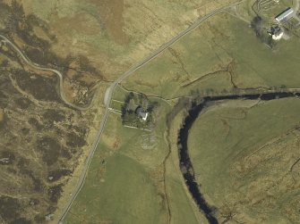 Oblique aerial view centred on the church and the remains of the broch, taken from the WSW.