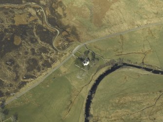 Oblique aerial view centred on the church and the remains of the broch, taken from the SW.