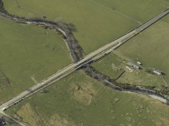 Oblique aerial view centred on the road bridges, taken from the SE.