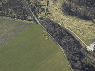Oblique aerial view centred on the remains of the henge, taken from the NW.