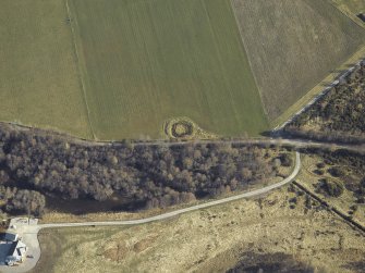 Oblique aerial view centred on the remains of the henge, taken from the SW.