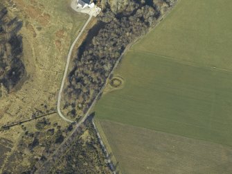 Oblique aerial view centred on the remains of the henge, taken from the ENE.