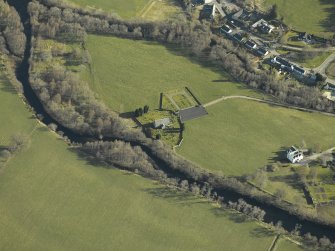 Oblique aerial view centred on the church, burial-ground and manse, taken from the SW.