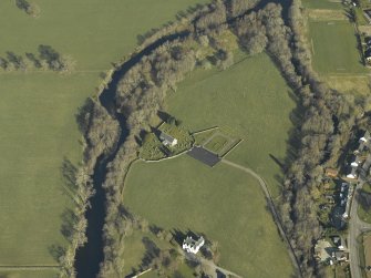 Oblique aerial view centred on the church, burial-ground and manse, taken from the SE.
