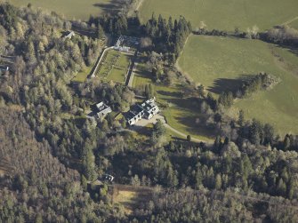 Oblique aerial view centred on the country house, gardens and cottages, taken from the SSW.
