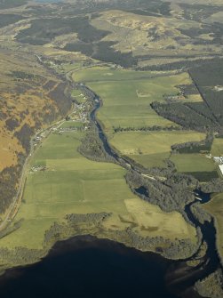 General oblique aerial view of the course of the Black Water centred on the farmsteading and the road bridge, taken from the SE.