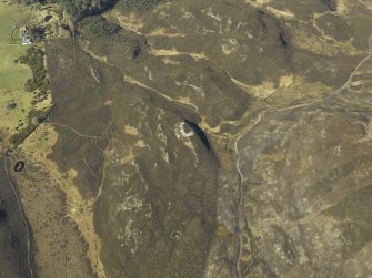 Oblique aerial view centred on the remains of the dun with the remains of the small cairns adjacent, taken from the NE.