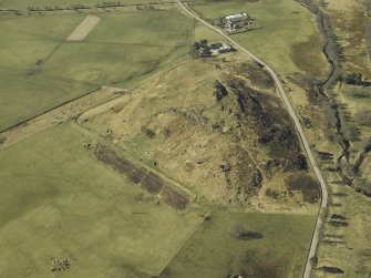 Oblique aerial view centred on the remains of the fort with the school adjacent, taken from the NE.