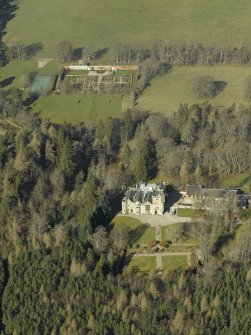 Oblique aerial view centred on the country house, formal garden, walled garden and stables, taken from the ESE.