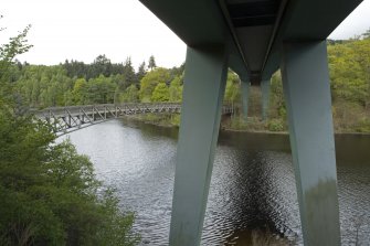 Elevated view from underside of road bridge to SE