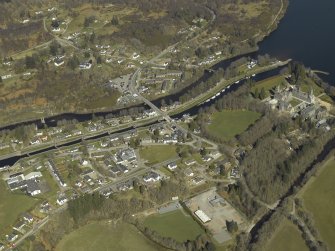 General oblique aerial view of the village centred on the road bridges, swing bridge, locks, abbey and schools, taken from the S.