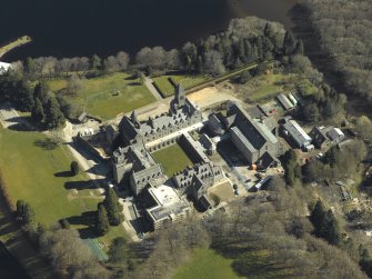 Oblique aerial view centred on the abbey and school, taken from the W.