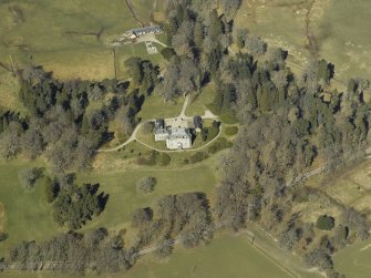 Oblique aerial view centred on the castle and garage with the stables and sawmill adjacent, taken from the SSE.