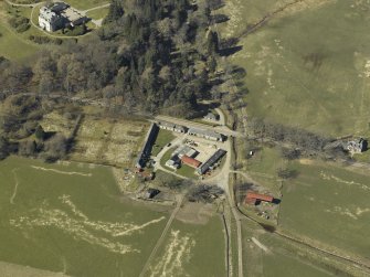 Oblique aerial view centred on the farmsteading, gate-lodge and walled garden, taken from the SE.