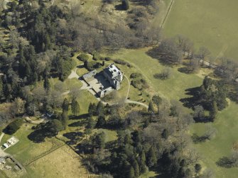 Oblique aerial view centred on the castle and garage, taken from the W.