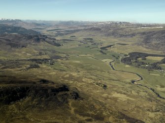 General oblique aerial view of the Spey Valley centred on the course of the military road with the castle adjacent, taken from the SE.