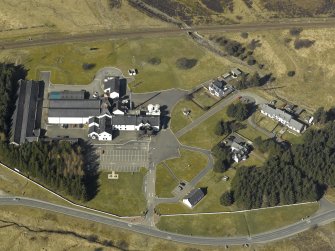 Oblique aerial view centred on the whisky distillery and bonded warehouse, taken from the SE.