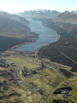General oblique aerial view of Loch Ericht centred on the dam and the village with Dalwhinnie whisky distillery and bonded warehouse in the foreground, taken from the NE.