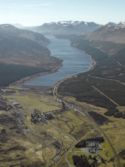 General oblique aerial view of Loch Ericht centred on the dam and the village with the whisky distillery and bonded warehouse in the foreground, taken from the NE.