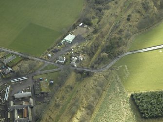 Oblique aerial view centred on railway station, taken from the NW.
