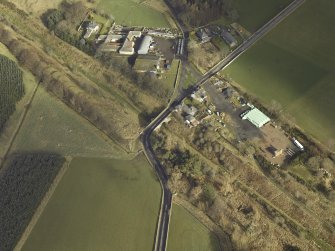 Oblique aerial view centred on railway station, taken from the SW.