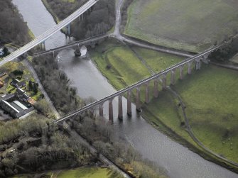 Oblique aerial view centred on the Leaderfoot railway viaduct, Drygrange Bridge and new road bridge, taken from the NW.