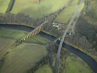 Oblique aerial view centred on the Leaderfoot railway viaduct, Drygrange Bridge and new road bridge, taken from the SE.