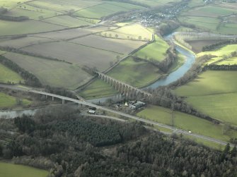 General oblique aerial view centred on the Leaderfoot railway viaduct, Drygrange Bridge and new road bridge, taken from the NE.