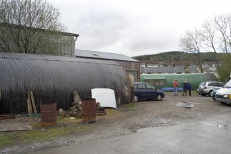 General view from S showing two Nissen huts and part of sheds.