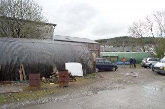 General view from S showing two Nissen huts and part of sheds.