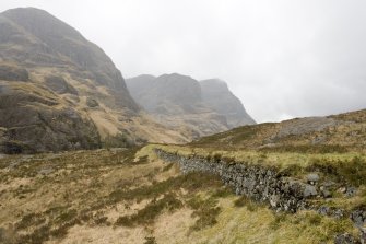 View from SE. Section of road crossing The Study showing stone revetting on S side.