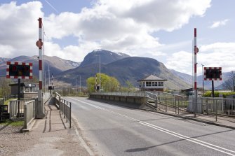 View.  from NW showing road swing bridge with barriers and railway signal box.