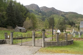 View from E.  Showing entrance gates to burial-ground with small chapel building in background.