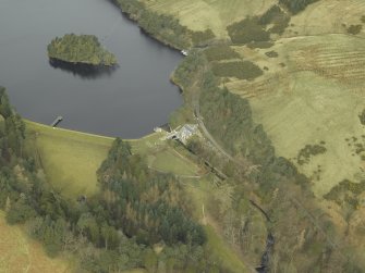 Oblique aerial view centred on the reservoir, dam and cottage, taken from the SE.