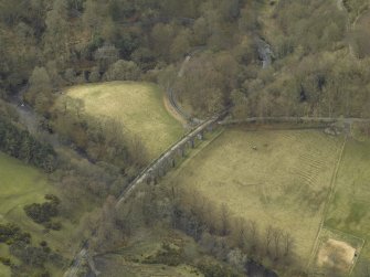 Oblique aerial view centred on the railway viaduct and the road bridge, taken from the NE.