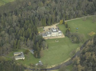 Oblique aerial view centred on the hotel and stables, taken from the S.