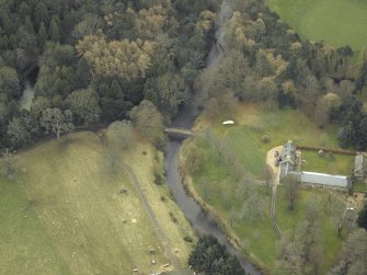 Oblique aerial view centred on the road bridge with the cottage and sawmill adjacent, taken from the NNE.