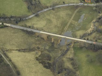 Oblique aerial view centred on the road bridge, taken from the NNE.