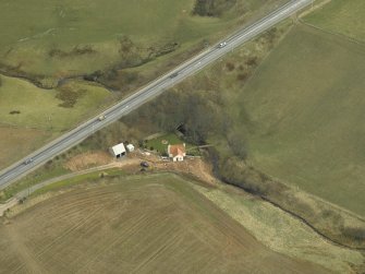 Oblique aerial view centred on the tunnel and the house, taken from the W.