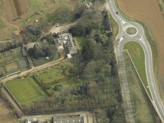 Oblique aerial view centred on the country house with the lodge adjacent, taken from the W.