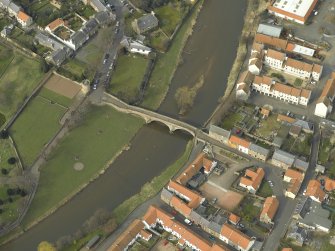 Oblique aerial view centred on the road bridge, taken from the SW.