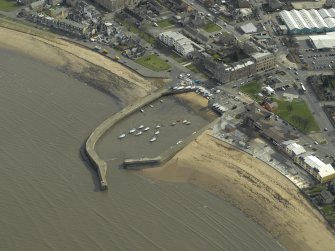 Oblique aerial view centred on the harbour and piers, taken from the WNW.