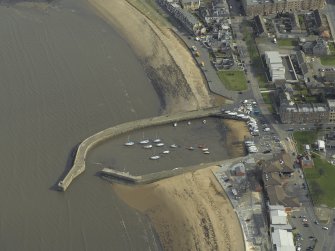 Oblique aerial view centred on the harbour and piers, taken from the W.