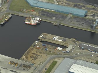 Oblique aerial view centred on the dock and the dry dock, taken from the S.