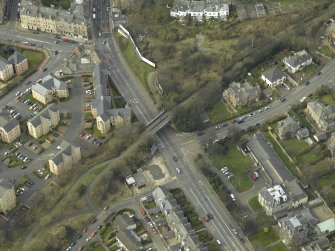 Oblique aerial view centred on the railway bridge, taken from the E.