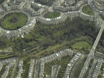 Oblique aerial view centred on the park and gardens with the road bridge adjacent, taken from the NW.