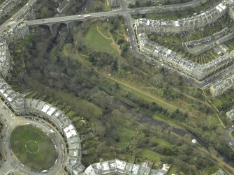 Oblique aerial view centred on the park and gardens with the road bridge adjacent, taken from the NE.